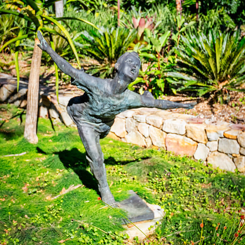 boy with arms out bronze sculpture